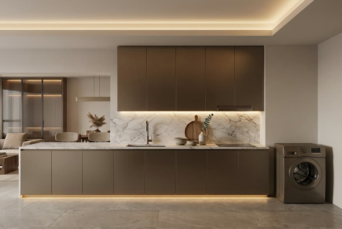 A kitchen with a dark island, a marble splashback and cove lighting