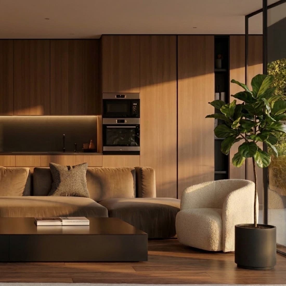 A living room in dark timber with built-in ovens, a low sofa and a fig tree